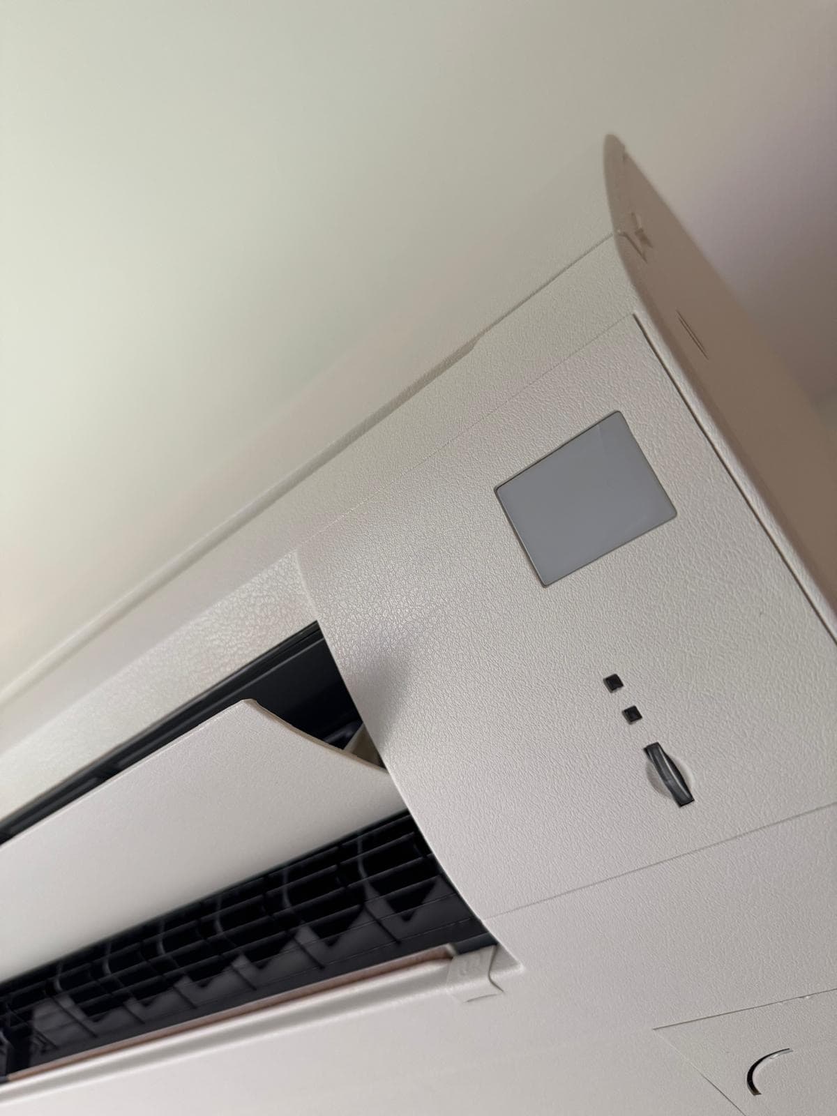 Completed white leather vinyl wrap on an aircon unit cover in Singapore.