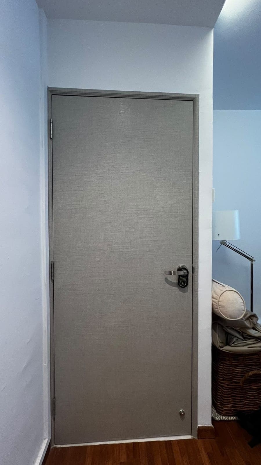 The bedroom door wrapped in a grey linen-look film