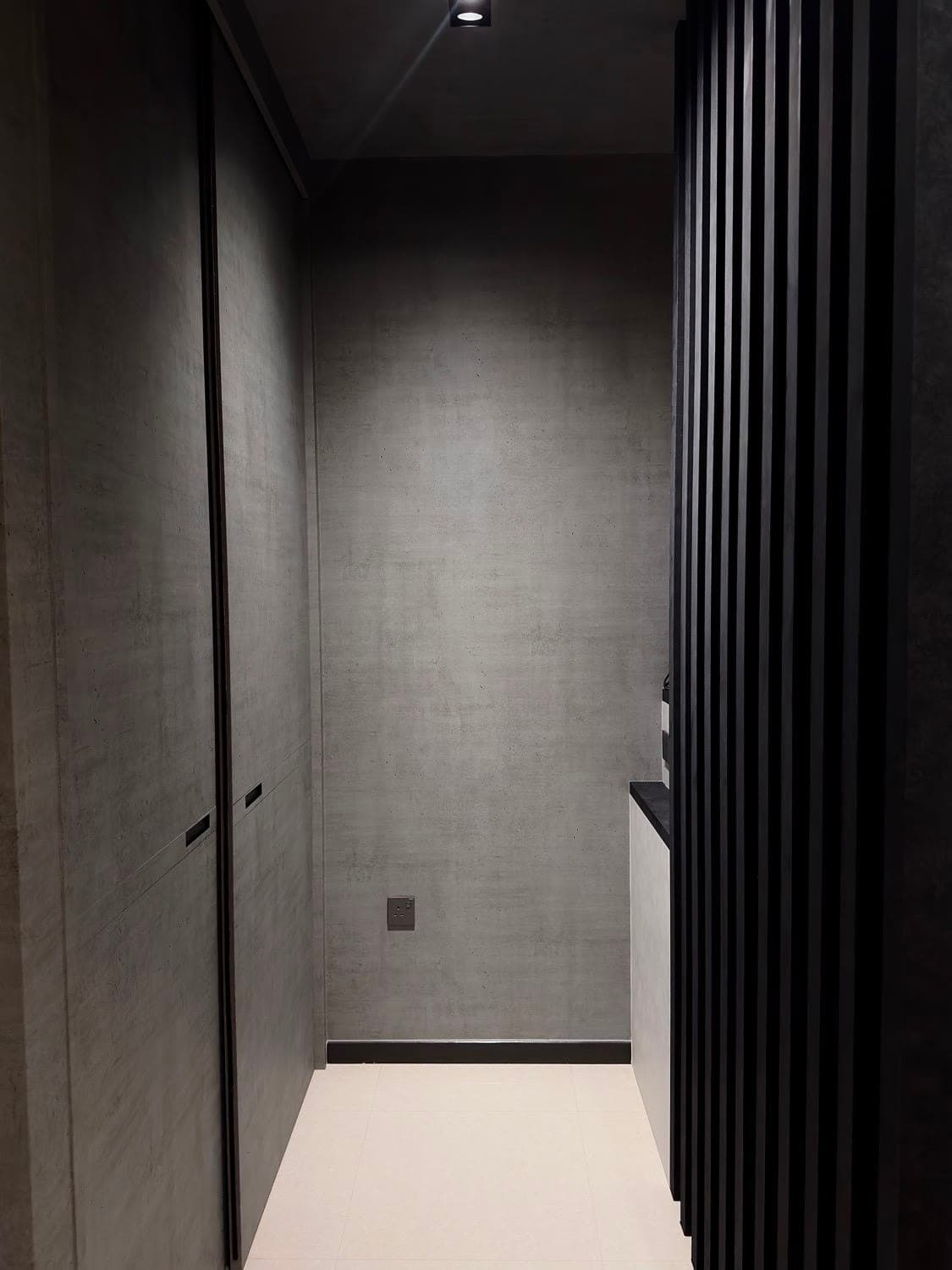 A wall of built-in doors wrapped in a dark textured film