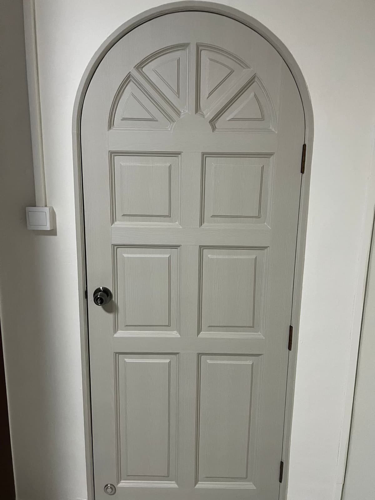 Arched panelled feature door refinished in clean white