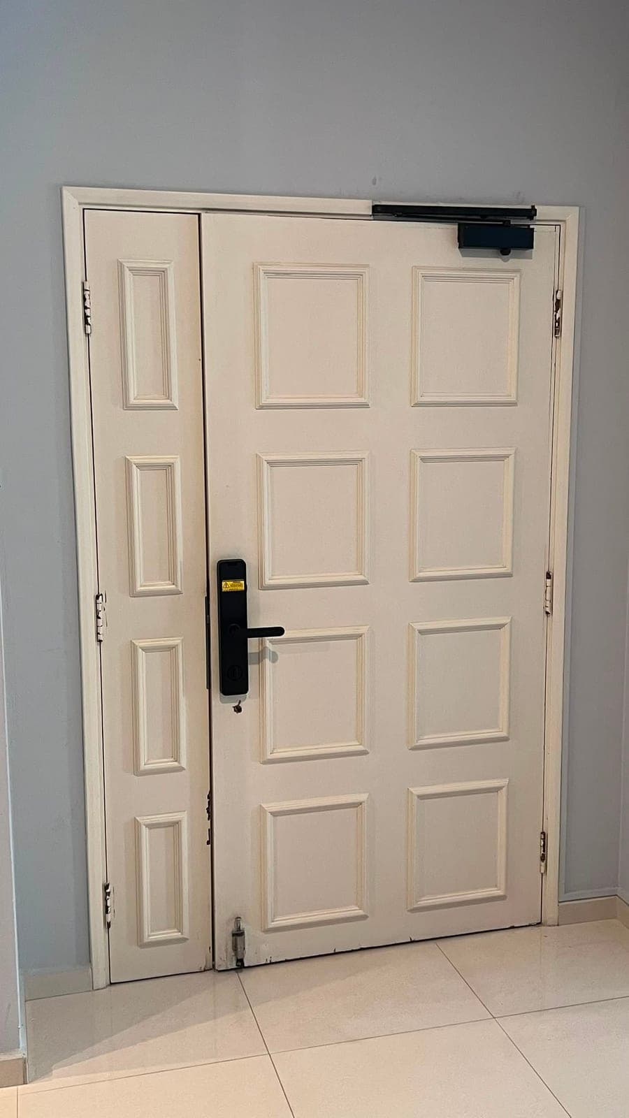 A white panelled double main door before wrapping