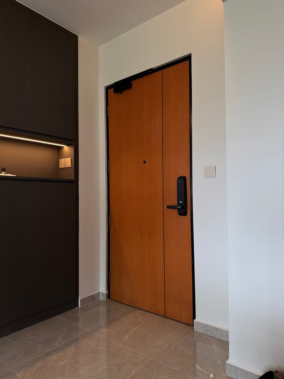 An orange wood-look main door in Punggol before wrapping