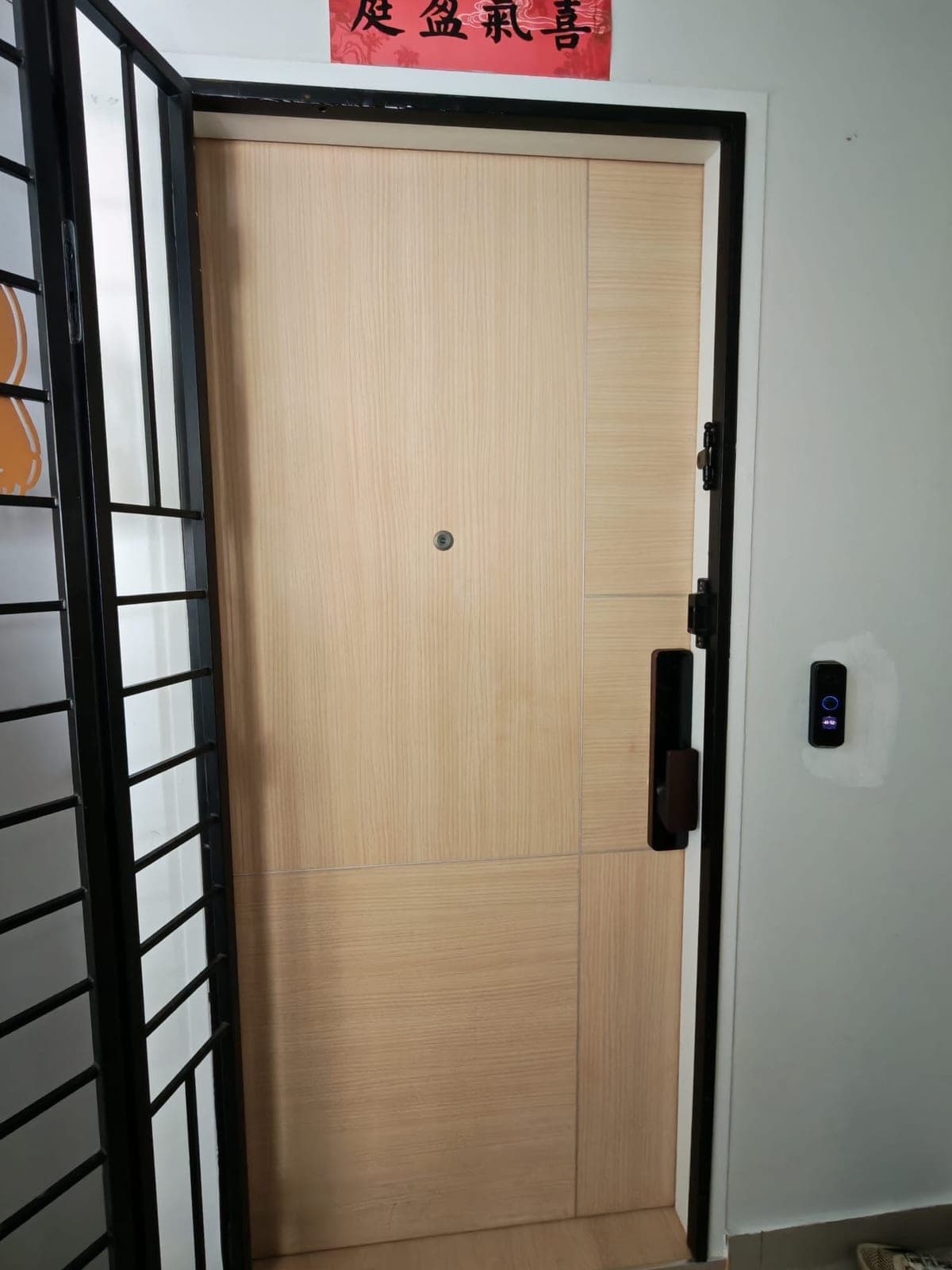A light oak-look main door in Toa Payoh before wrapping