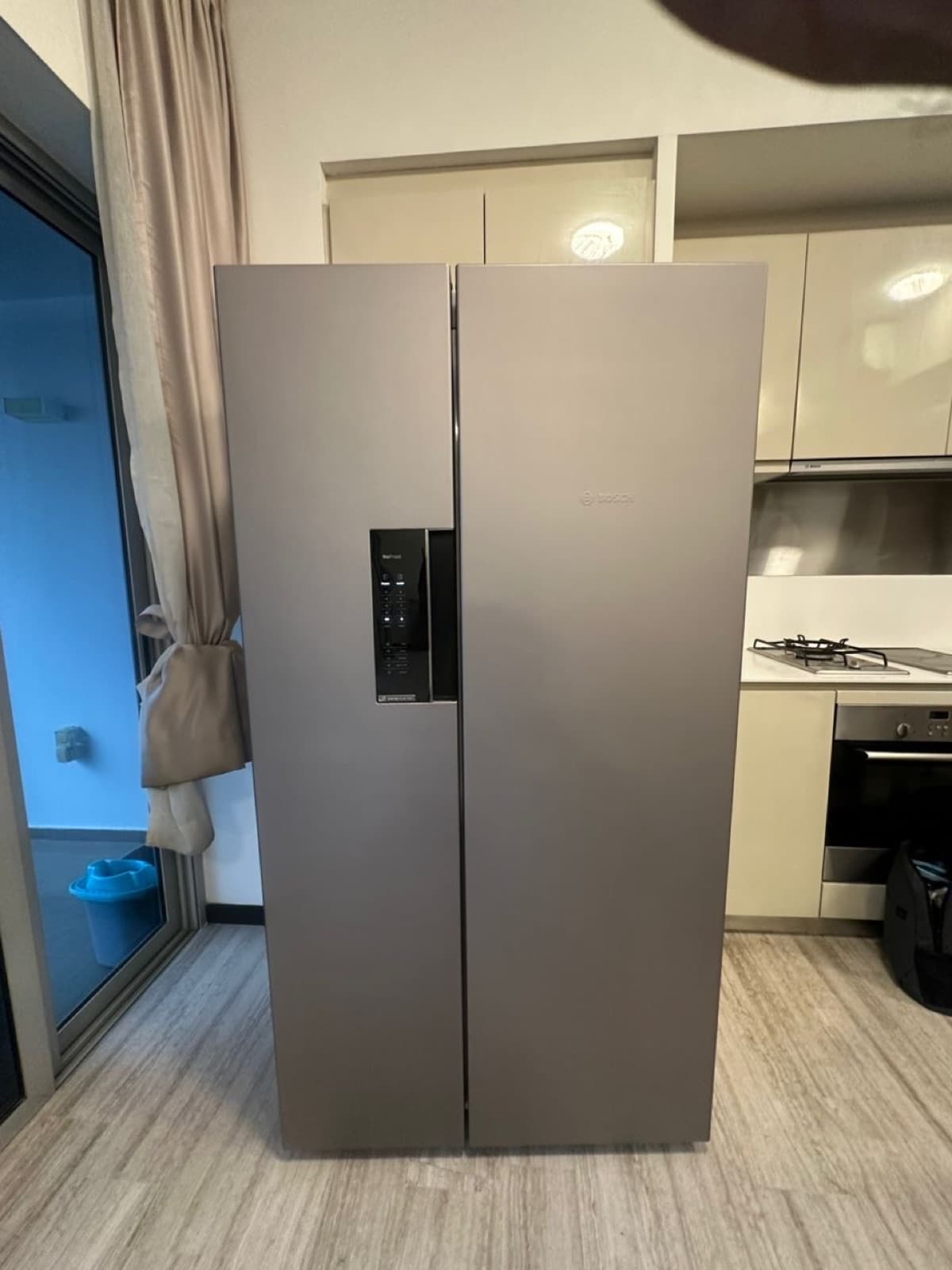 Refrigerator wrapped in a metallic grey finish