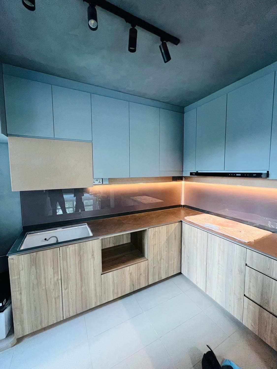 Kitchen cabinets in pale blue and light oak before wrapping