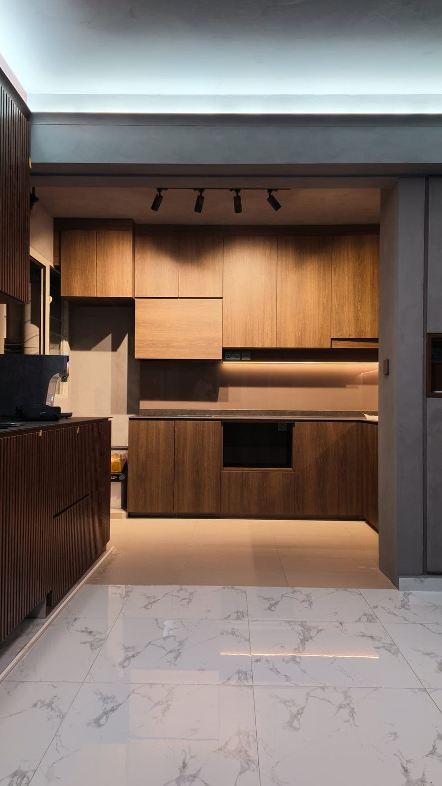 A kitchen in Tampines wrapped in a walnut-look film