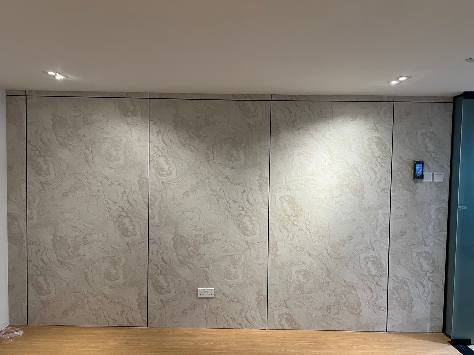 Living room feature wall finished in a marble-swirl textured film