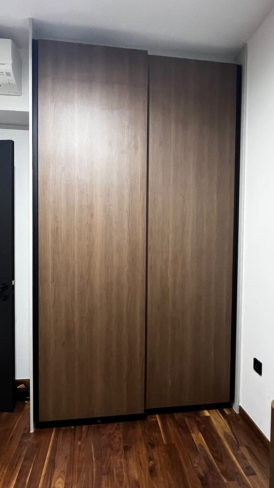 Sliding wardrobe doors in Katong wrapped in a walnut-look film