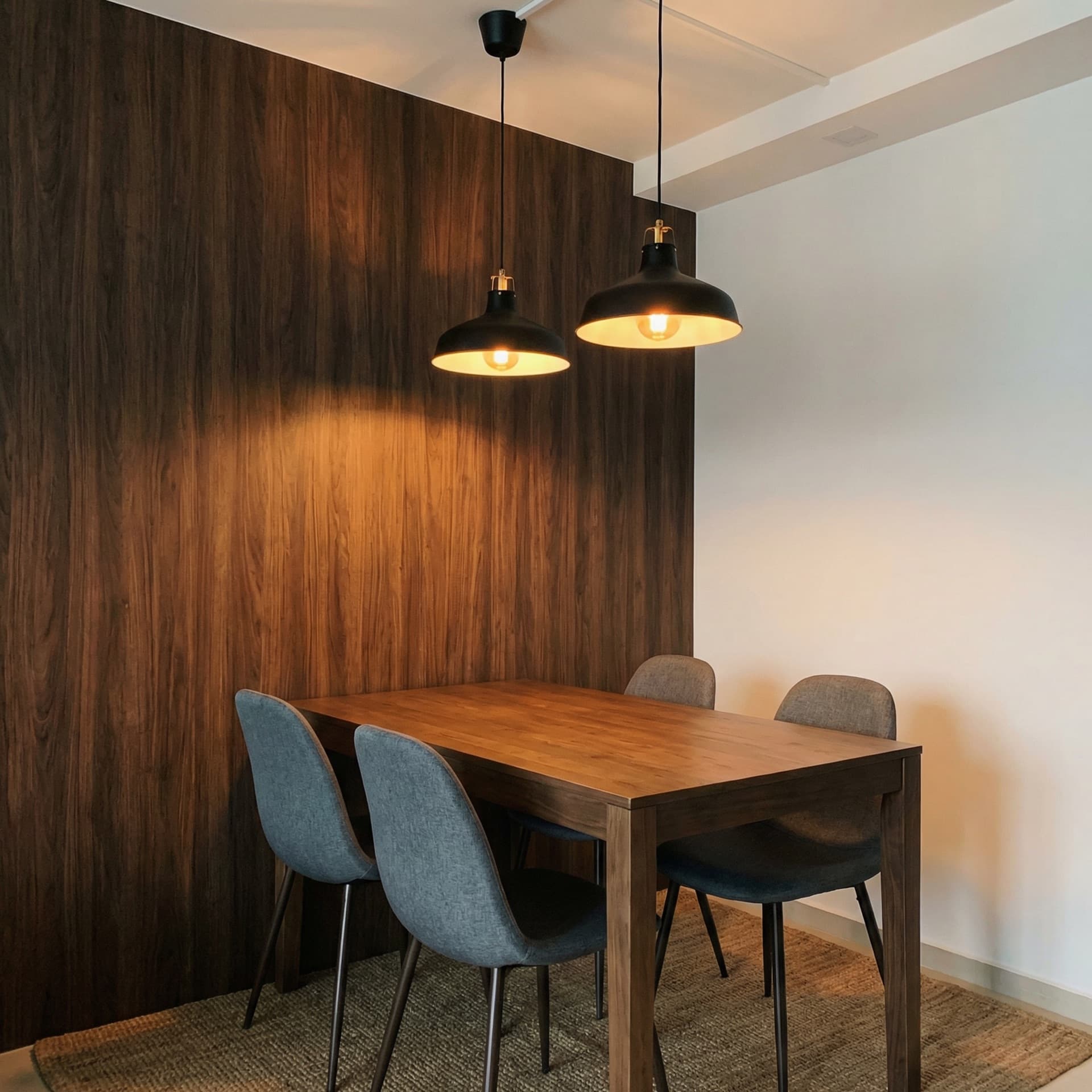 Dining area with dark walnut wood-grain feature wall