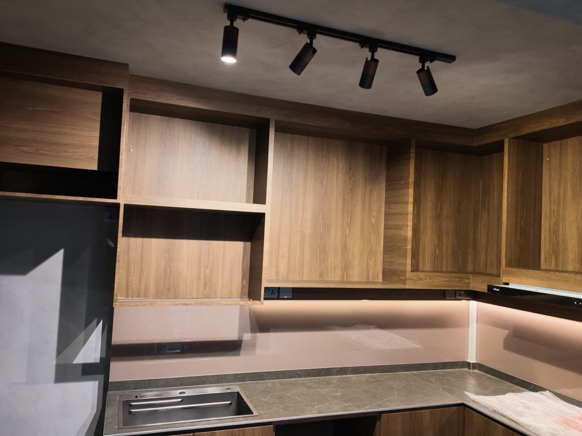 Kitchen cabinets after wrapping with walnut wood-grain architectural film