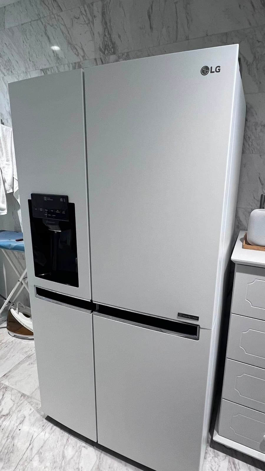 The side-by-side fridge wrapped in a matte light grey film