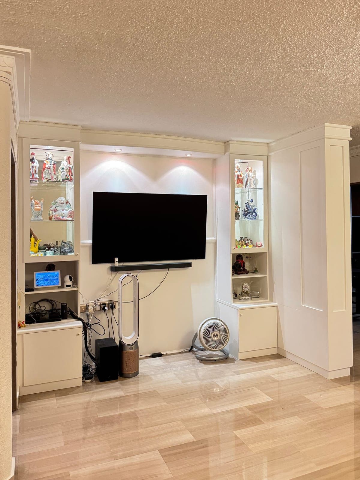 The TV wall and display cabinet wrapped in white