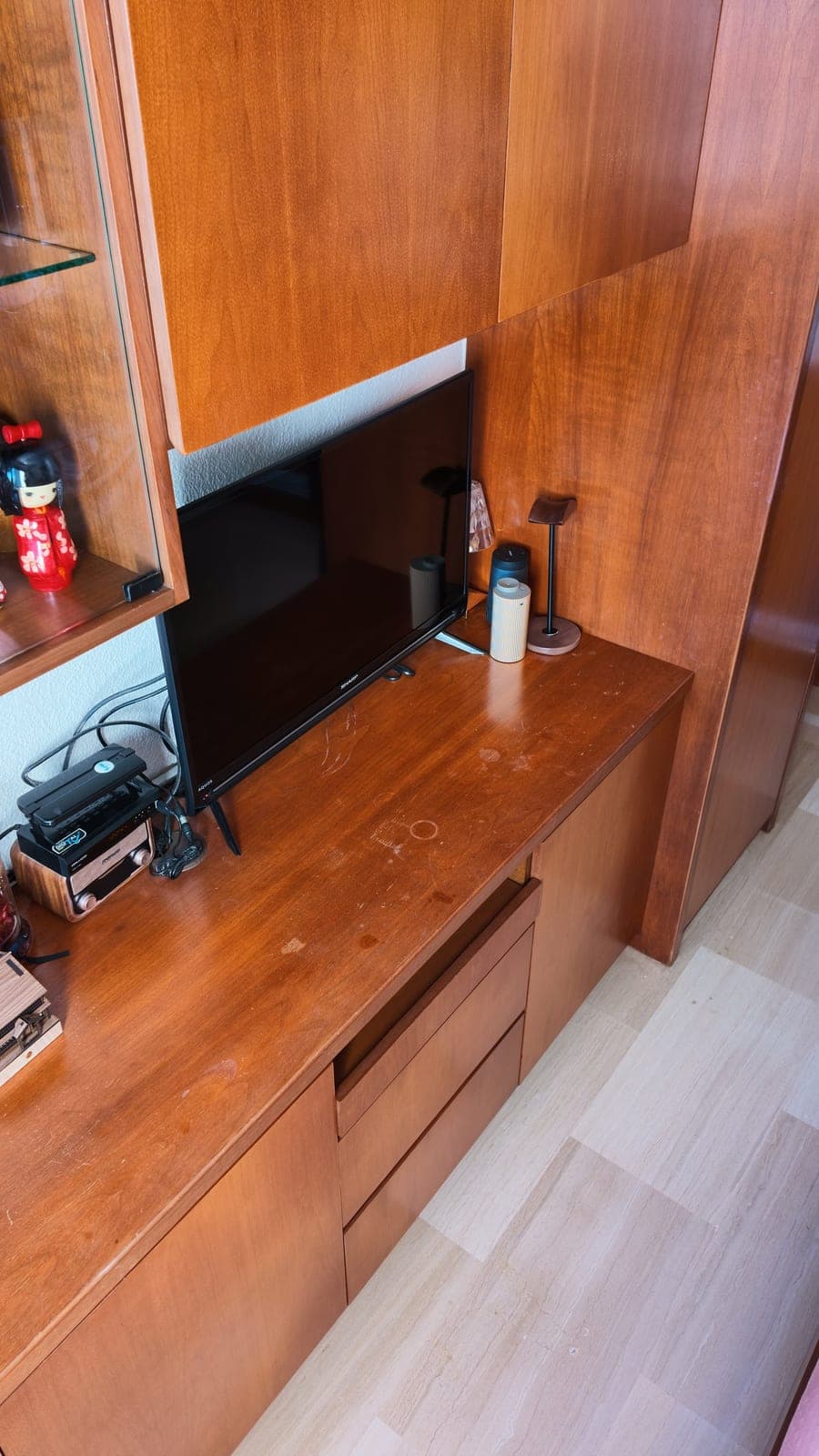 Cherry wood built-in cabinets above a TV console in Bukit Merah before wrapping